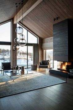 a living room filled with furniture and a fire place in front of a window covered in snow