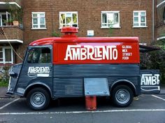 an ambrento food truck parked in front of a brick building