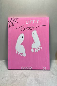 a pink canvas with two little boos painted on it