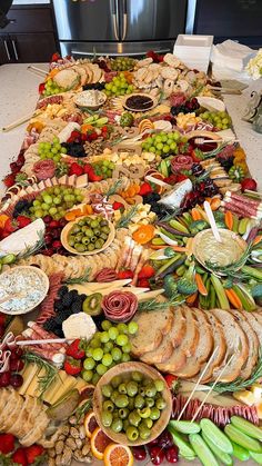 a long table covered with lots of different types of food and snacks on it's sides