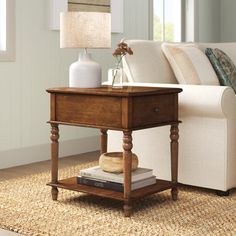 a living room scene with focus on the end table and sofa in the back ground