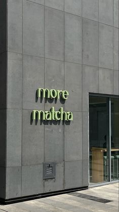 there is a sign that says more matcha on the side of a building,