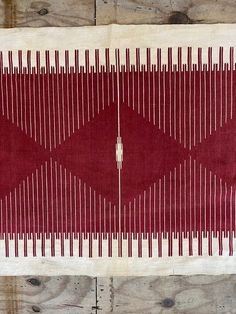 a red and white rug with lines on it