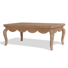 a wicker bench with scalloped legs