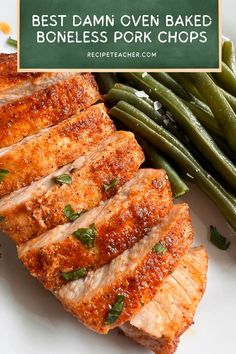 the best damn oven baked boneless pork chops on a white plate with green beans