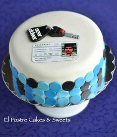 a close up of a cake on a table with a name tag attached to it