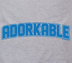 the word adorkable written in blue on a grey shirt