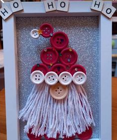 a photo frame that has buttons and yarn on it with the words ho hoo