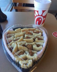 a heart shaped pie sitting on top of a table next to a cup