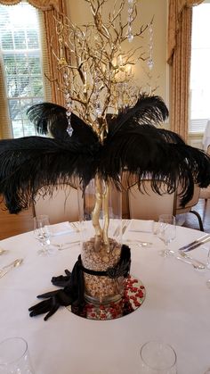 a table topped with a cake covered in feathers