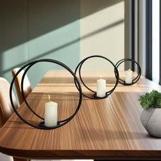 a wooden table topped with two white candles