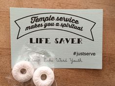 two white donuts sitting on top of a piece of paper next to a sign