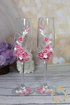 two wine glasses decorated with pink and white flowers