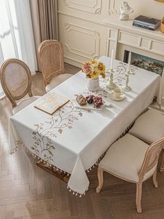 a dining room table covered with a white table cloth