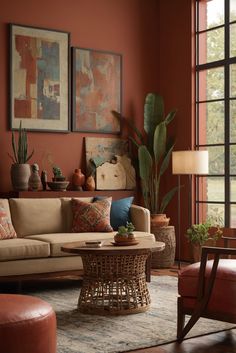 a living room filled with furniture and lots of plants on top of the walls in front of large windows