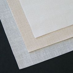 three pieces of white fabric on top of each other