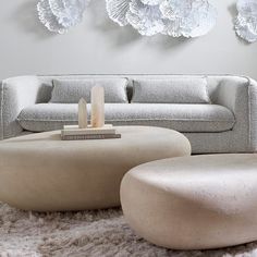 a modern living room with large paper flowers on the wall above the couch and coffee table