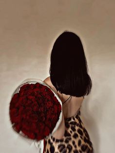 a woman holding a bouquet of red roses