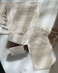 the wedding stationery is laid out with matches