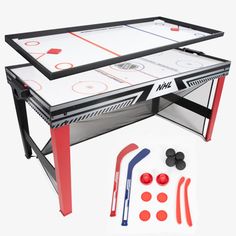 two air hockey tables with accessories for the table top and one set up to play