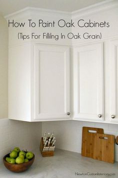 white cabinets in a kitchen with green apples on the counter