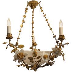 an antique chandelier with flowers and leaves