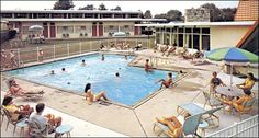 an outdoor swimming pool with people in it