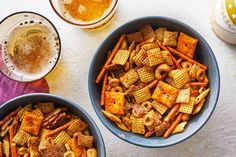 two bowls filled with cheetos and beer next to each other on a table