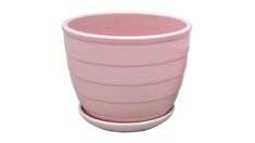 a pink cup sitting on top of a white table