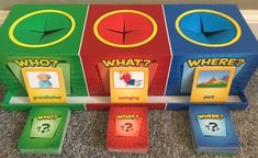 three colorful boxes with question marks on them sitting on the floor next to each other