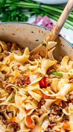 a skillet filled with pasta and meat