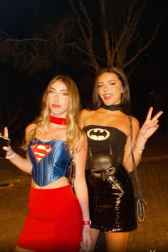 two women dressed in costumes posing for the camera