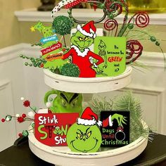 three tiered christmas cake decorated with green and red items, including candy canes