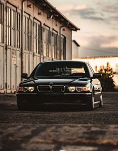 a black car parked in front of a building