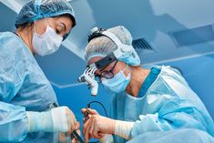 two doctors performing surgery in an operating room