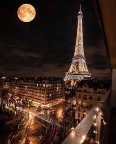 the eiffel tower is lit up at night