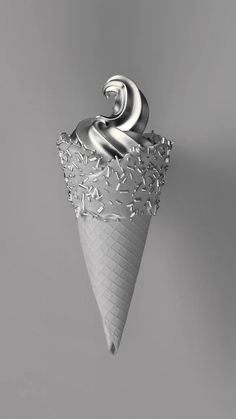 an ice cream cone with silver swirls on it's top is floating in the air