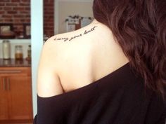 the back of a woman's shoulder with a tattoo saying, every good thing