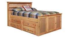 a wooden bed with drawers underneath it and a pillow on top of the headboard