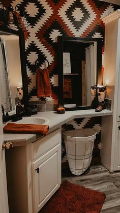 the bathroom is decorated in black, white and orange colors with an interesting pattern on the wall