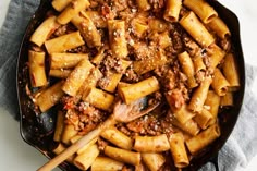 a skillet filled with pasta and meat