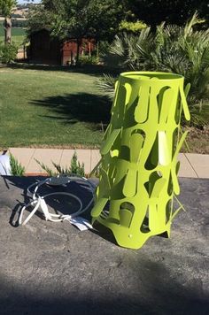 a yellow vase sitting on the ground next to a bike