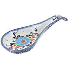 a blue and white glass spoon with flowers on it