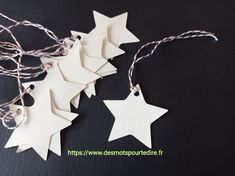 white paper stars hanging from string on black surface