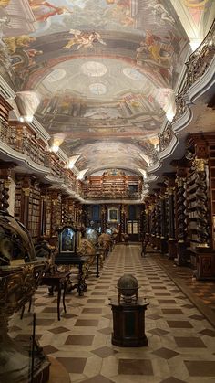 the inside of a library with many bookshelves and paintings on the ceiling,