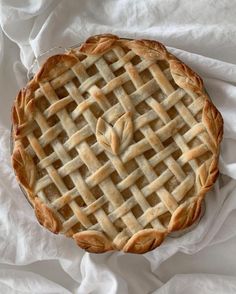 a pie sitting on top of a white table cloth