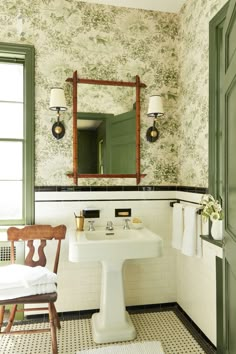 the bathroom is decorated in green and white with an antique style mirror above the sink