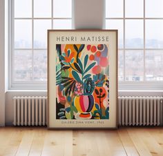 there is a poster on the floor in front of a window that says henry matissee