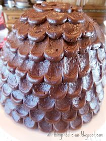 a large chocolate cake sitting on top of a white plate