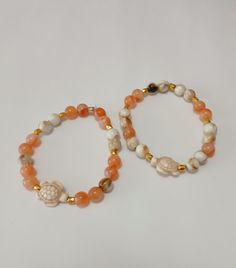 Beaded Bracelets (2). Peach, tan/cream, gold with sea turtle. Adjustable Multicolor Beaded Bracelets, Ocean-inspired, Adjustable Ocean-inspired Beaded Bracelets With Lobster Clasp, Beaded Necklaces, Sea Turtle, Favorite Jewelry, Beauty Book, Beaded Necklace, Beaded Bracelets, Jewelry Necklaces